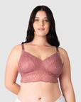 Olivia confidently wears the Heroine nursing bralette by Hotmilk Lingerie, featuring soft lace for everyday comfort. This versatile multi-fit nursing bralette adapts miraculously to various sizes, making it perfect for uncertain sizing needs. It evolves with your changing cup shapes during your entire breastfeeding journey