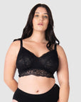 Olivia wears the Heroine nursing bralette in 36D-I by Hotmilk Lingerie US, highlighting the sheer soft lace back and intricate multi-strap detailing. An ideal choice to include in your hospital delivery bag. This versatile crop-style nursing bralette effortlessly accommodates various sizes, perfectly suited for the postpartum phase. It caters to uncertain sizing needs and seamlessly adapts to changing cup shapes, ensuring comfort throughout your entire breastfeeding journey