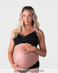 Pregnant model wearing the Hotmilk Caress FlexFit Nursing Bra in Black with matching briefs – front view showing wirefree silhouette, lace trim neckline, and supportive fit during pregnancy