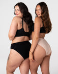 Two models wearing the Hotmilk My Necessity Seamless Bikini Briefs – rear view showing Black and Frappe colourways and mid-coverage fit across two different body shapes, paired with the My Everyday Nursing Bra in Black
