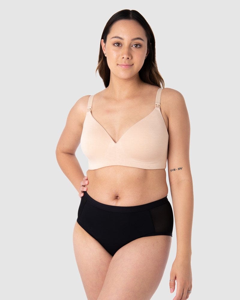 Tatiana exudes confidence, comfortably protected against light and unexpected leaks in Hotmilk Lingerie's Embrace Leakproof Bra in Frappe. This innovative take on the classic T-shirt bra is meticulously crafted from soft, eco-friendly bamboo yarn and features a leakproof foam cup. It ensures enduring freshness, dryness, and unwavering confidence for nursing mothers