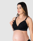 Close-up of Kami, pregnant mother of two, demonstrating the functionality of the HOTMILK US nursing and maternity bra named AMBITION T-SHIRT WIREFREE in black, featuring the convenient magnetic nursing clip