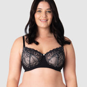 Olivia elegantly showcases Hotmilk's award-winning flexi underwire maternity and nursing bra, Temptation in Black. This versatile everyday black lace full cup bra provides ample lift and support. With fully adjustable straps, it's suitable for both date nights and all-day wear, making it an ideal choice for breastfeeding mothers