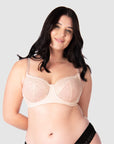Experience complete support with Hotmilk Lingerie US's Temptation in Powder. This acclaimed award-winning style boasts flexi underwire, a hint of sheer lace over soft cotton cups, convenient nursing clips, and elevated all-day comfort and support. Olivia confidently wears size 14/36D in this essential nursing and maternity bra