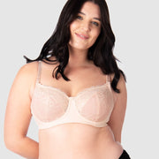 Experience complete support with Hotmilk Lingerie US's Temptation in Powder. This acclaimed award-winning style boasts flexi underwire, a hint of sheer lace over soft cotton cups, convenient nursing clips, and elevated all-day comfort and support. Olivia confidently wears size 14/36D in this essential nursing and maternity bra