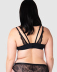 View the rear of Hotmilk Lingerie's True Luxe nursing bra in black, showcasing the captivating twin strap details that exude romance. With 6 rows of hook and eyes, this bra ensures maximum comfort throughout every stage of pregnancy and nursing. The flexi underwire support caters to larger bust sizes, up to J cup. Experience uncompromised inclusive maternity and nursing style at its finest
