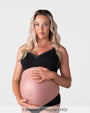 Pregnant model wearing the Hotmilk Caress FlexFit Nursing Bra in Black with matching briefs – front view showing wirefree silhouette, lace trim neckline, and supportive fit during pregnancy