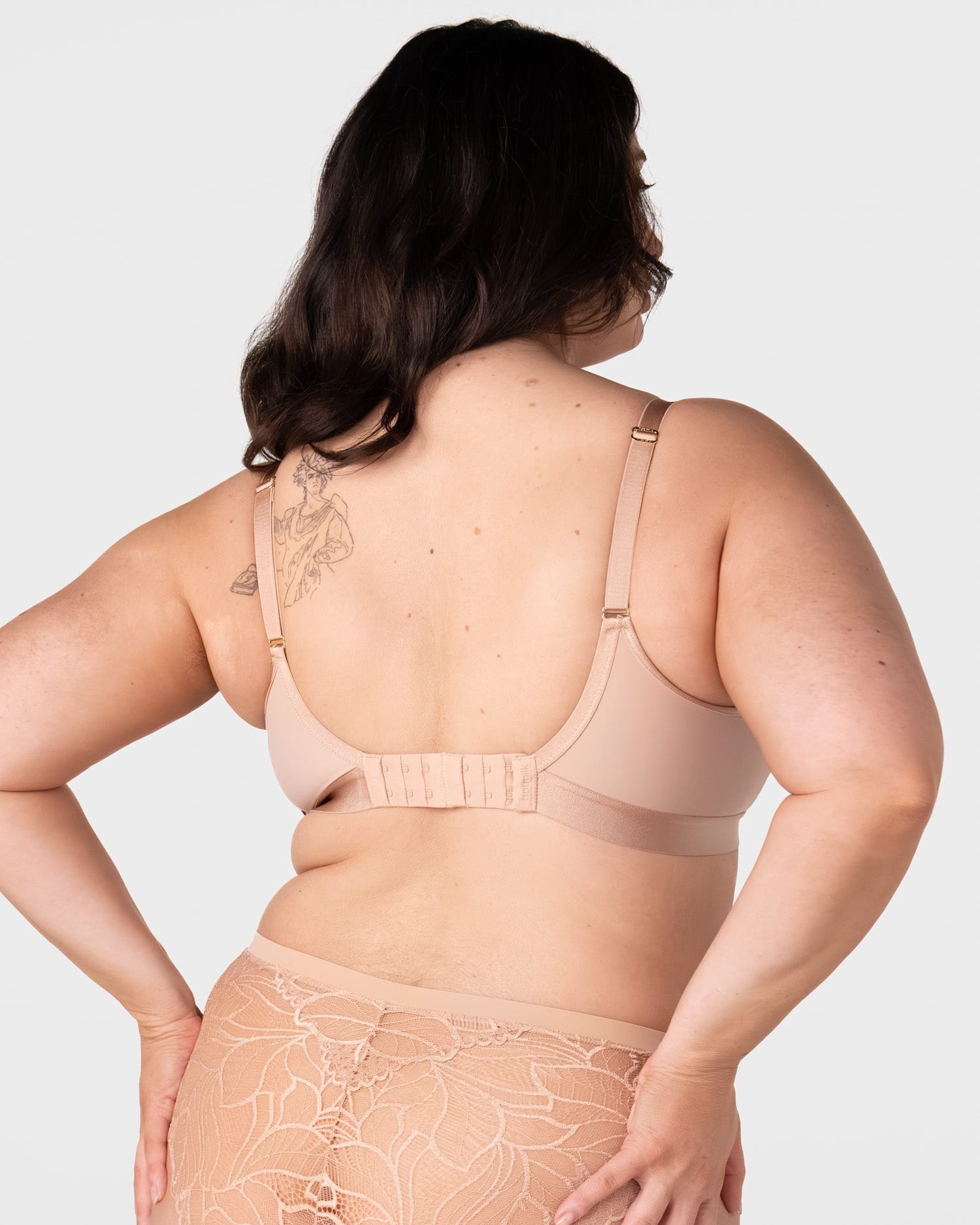 Rear view of model wearing the Hotmilk Flawless Plunge Wirefree Nursing Bra in Cashmere – showing 6-hook back closure, gold adjustable straps, and double-layer smoothing back panel with matching lace briefs