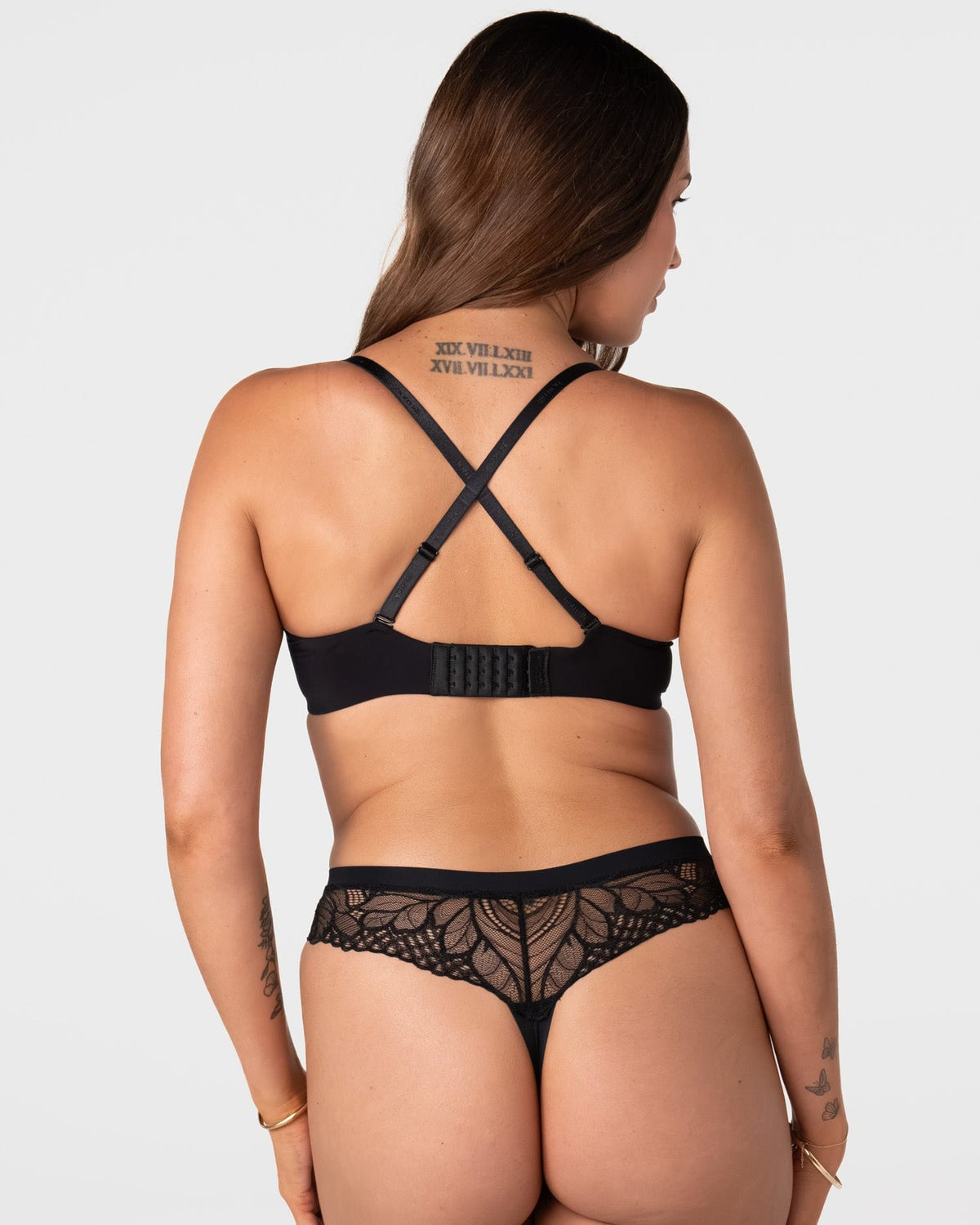 Forever New black maternity t-shirt bra worn in racerback style with crossed-over adjustable straps and wide 6 hook closure