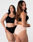 Two models wearing the Hotmilk My Necessity Seamless Bikini Briefs in Black and Frappe – three-quarter view showing smooth seamless fit and flexible everyday silhouette, paired with the My Everyday Nursing Bra in Black
