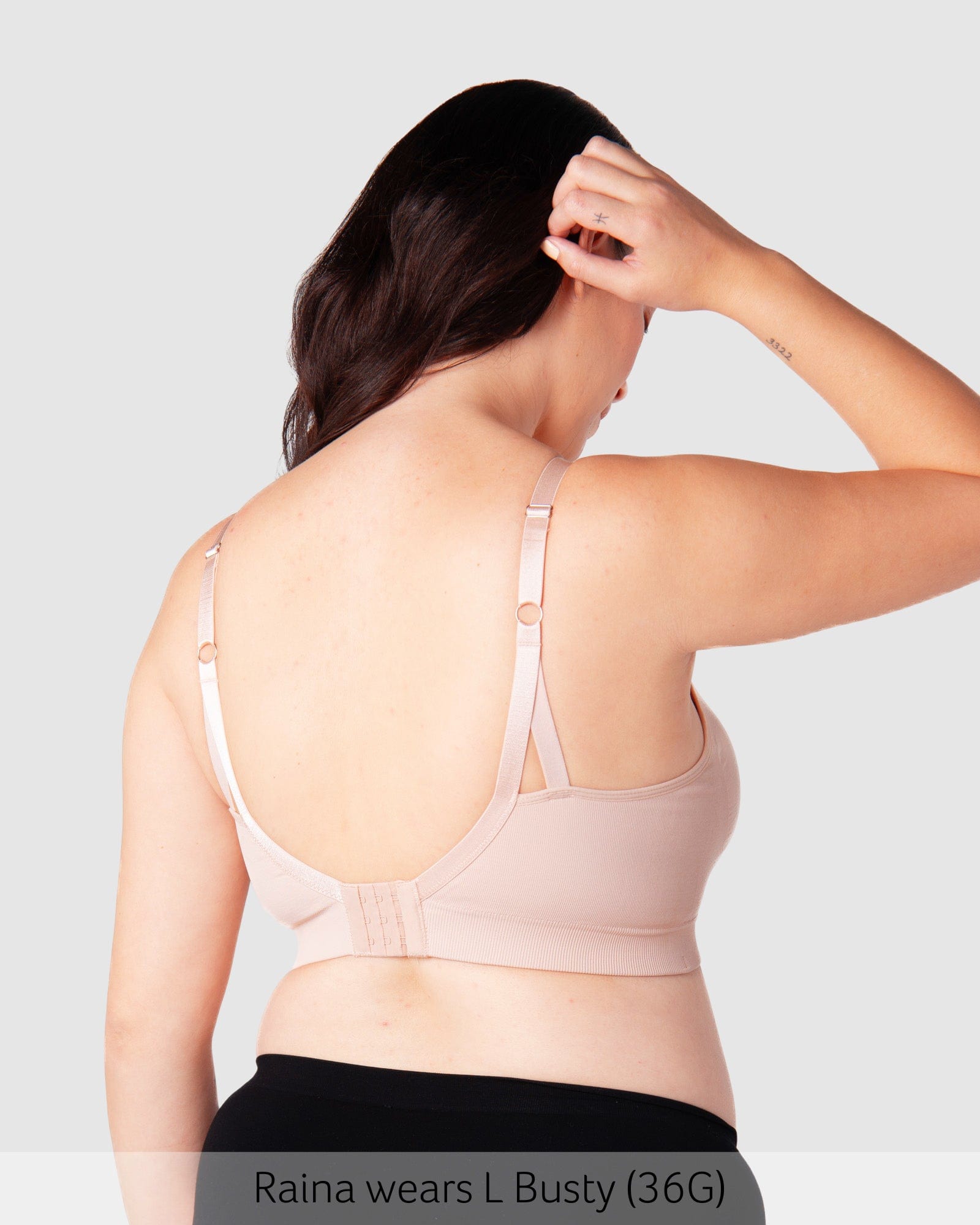 Model wearing Hotmilk My Necessity bra in Ballet Pink, showing back view.