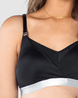 Explore the close-up details of Hotmilk Lingerie's nursing and pumping bra, showcasing slinky microfiber and featuring the brand's signature magnetic nursing clips. Finished with a contrasting silver underband, this innovative design seamlessly combines the convenience of nursing and pumping in one. Elevate your breastfeeding and pumping experience with the style and functionality embodied by Hotmilk Lingerie's dual-purpose bra