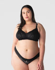 Tiare wears the best-selling sheer lace nursing bralette from Hotmilk Lingerie US. The Heroine nursing bralette is essential for hospital bags and an ideal gift for new mothers. This versatile crop-style nursing bra adapts to varying cup sizes, simplifying postpartum breastfeeding