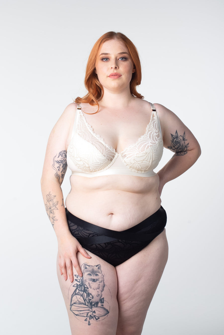 Ali, stunningly shows off the Warrior Plunge Ivory nursing and breastfeeding bra by Hotmilk Lingerie. Featuring an edgy design, graphic lace, and magnetic clips for added flair, this ensemble is elevated by the supportive features of contour cups and flexi underwire, providing both comfort and lift